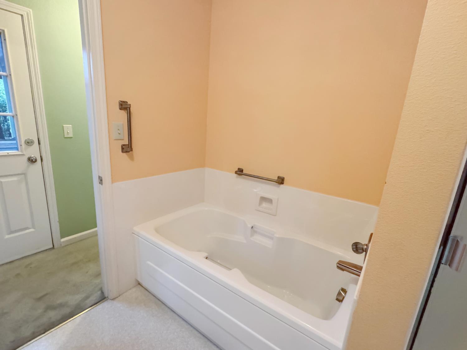 12439 Homestead Way Auburn, CA 95603 - Photo 20 of 27 a white bath tub sitting next to a white sink and vanity