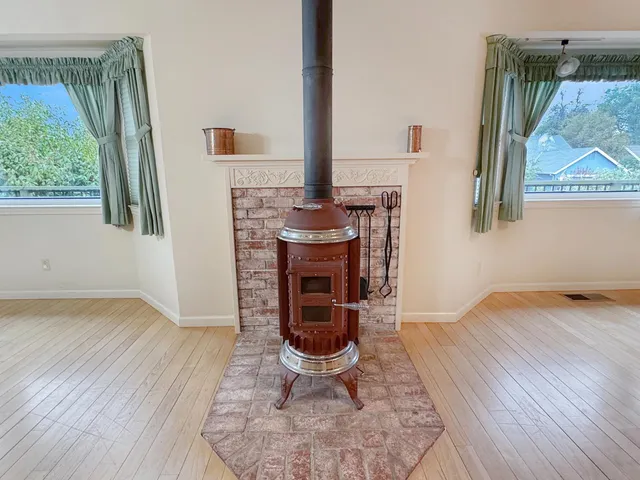 a living room with furniture a window and a fireplace