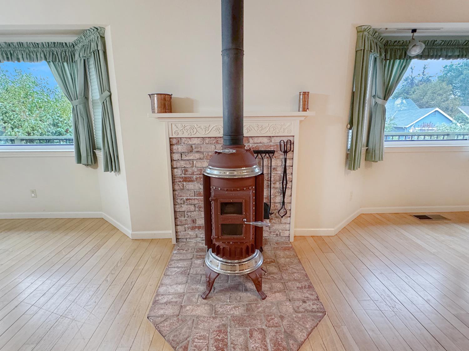 12439 Homestead Way Auburn, CA 95603 - Photo 6 of 27 a living room with furniture a window and a fireplace