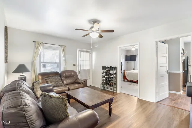 a living room with furniture and a chandelier