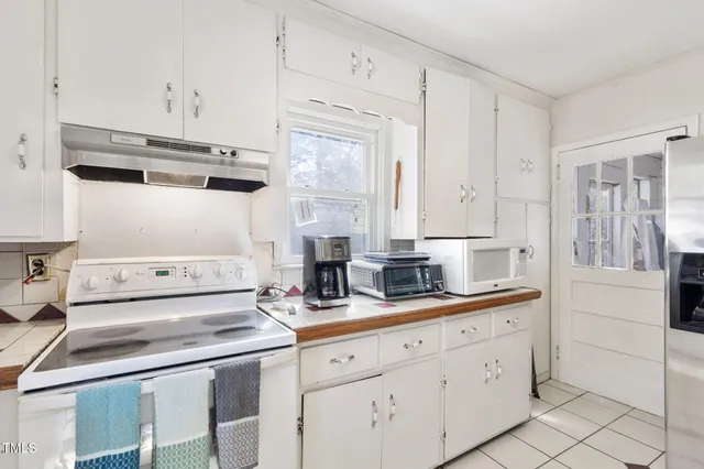 a kitchen with appliances cabinets and a sink
