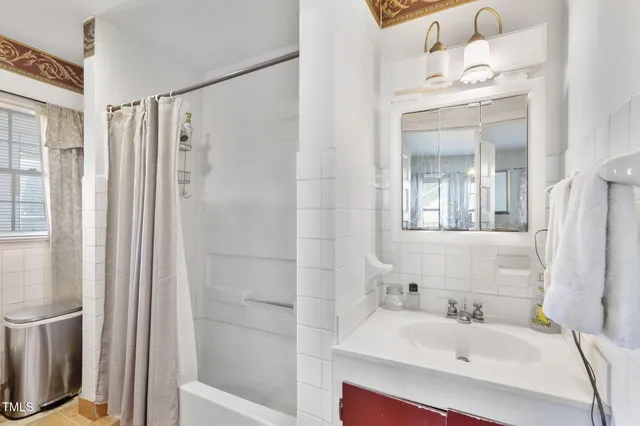 a bathroom with a sink a mirror and a shower