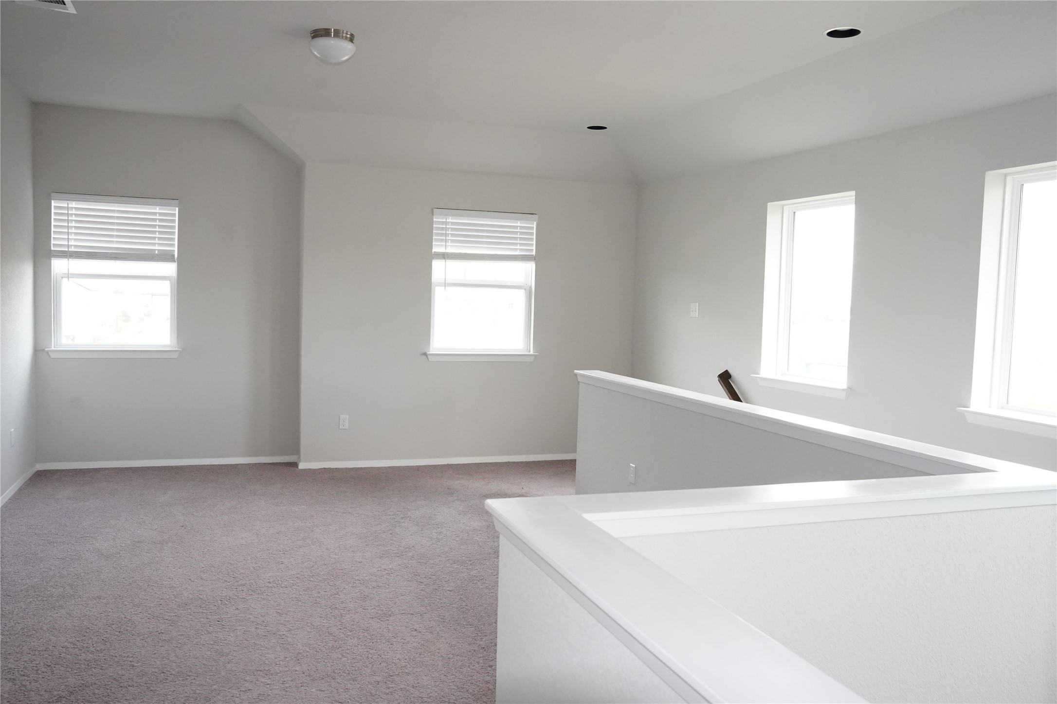 117 Crescent Street Georgetown, TX 78626 - Photo 26 of 38 A versatile open loft space featuring vaulted ceilings and abundant natural light.