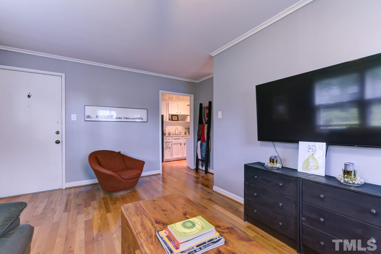 821 Daniels Street, Unit B Raleigh, NC 27605 - Photo 12 of 25 a living room with furniture and a flat screen tv