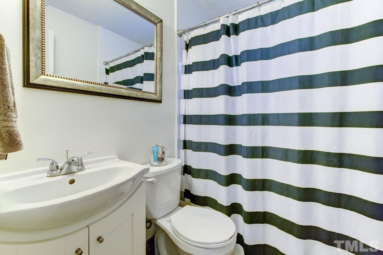 821 Daniels Street, Unit B Raleigh, NC 27605 - Photo 14 of 25 a bathroom with a sink a toilet a shower and a mirror