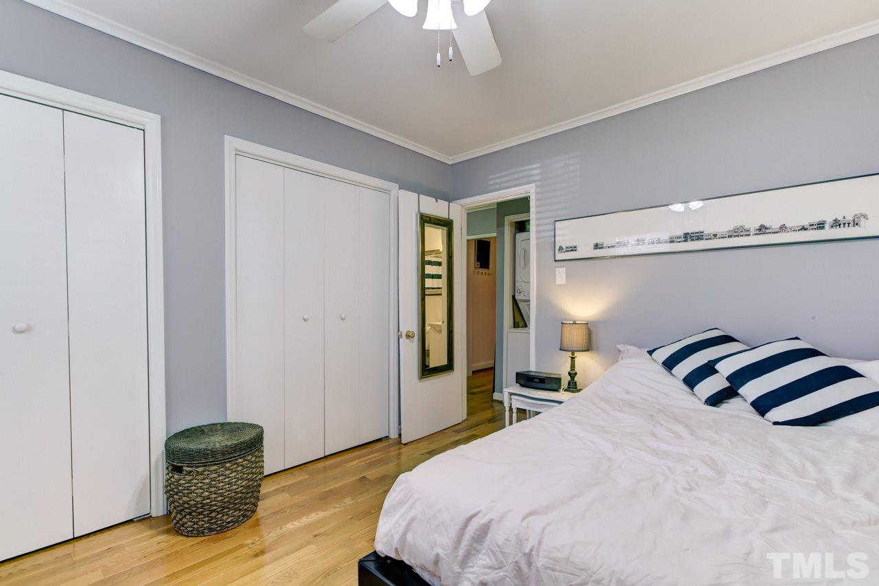 821 Daniels Street, Unit B Raleigh, NC 27605 - Photo 16 of 25 a bedroom with a bed and a chandelier