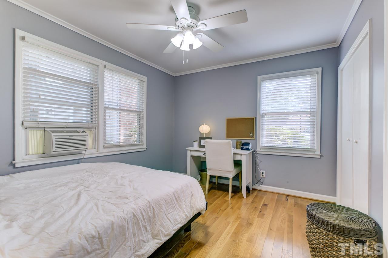 821 Daniels Street, Unit B Raleigh, NC 27605 - Photo 17 of 25 a bedroom with a bed and a table