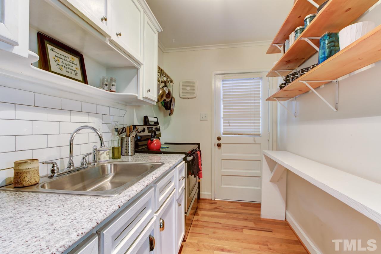 821 Daniels Street, Unit B Raleigh, NC 27605 - Photo 7 of 25 a kitchen with a sink a stove and cabinets