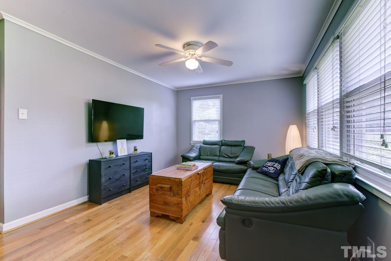 821 Daniels Street, Unit B Raleigh, NC 27605 - Photo 10 of 25 a living room with furniture and a flat screen tv