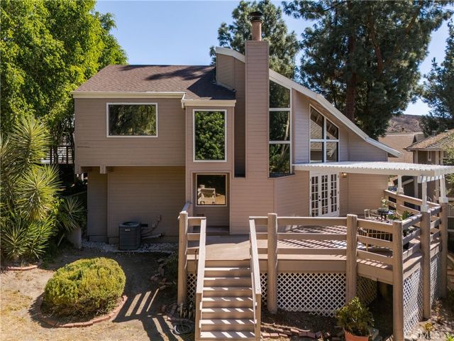 a view of a house with backyard and sitting area