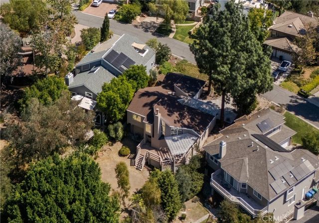 an aerial view of multiple houses with yard