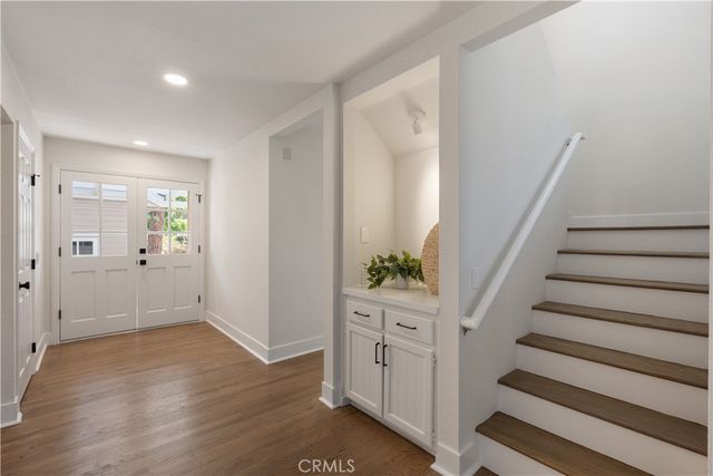 a view of an entryway with wooden floor