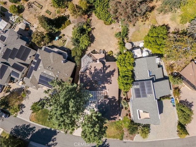 an aerial view of a house with a yard and garden