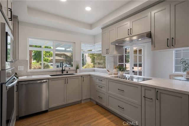 a kitchen with sink cabinets and wooden floor