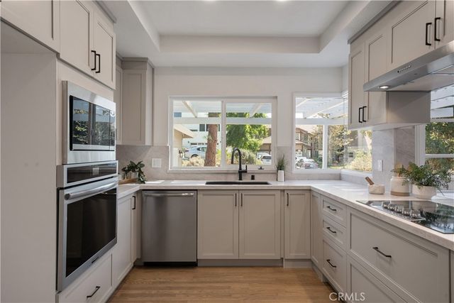 a kitchen with a sink stove and cabinets
