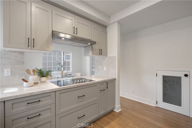 a kitchen with cabinets and window