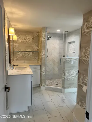 a bathroom with a shower and a sink