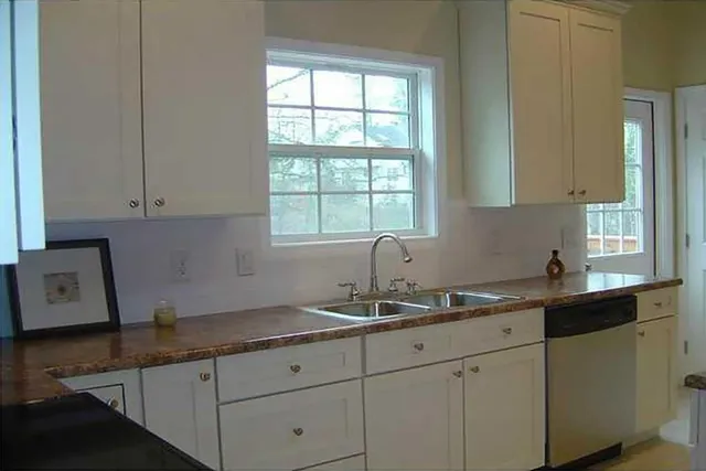a kitchen with sink and cabinets