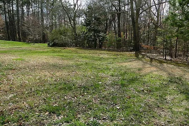 a view of balcony with wooden floor and fence