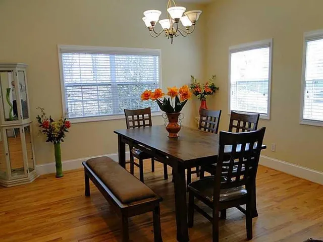 a view of a dining room with furniture window and wooden floor