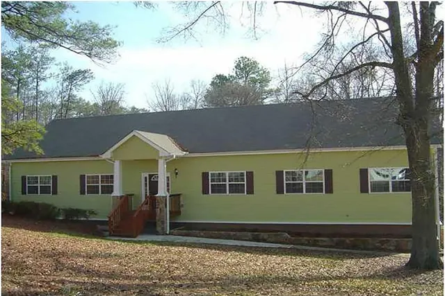 a view of house with yard