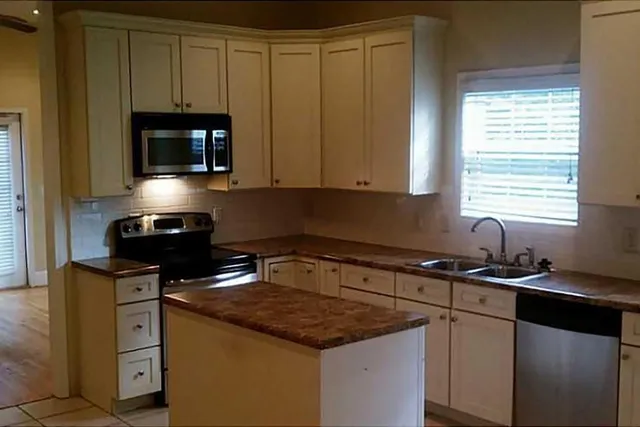 a kitchen with a sink and cabinets
