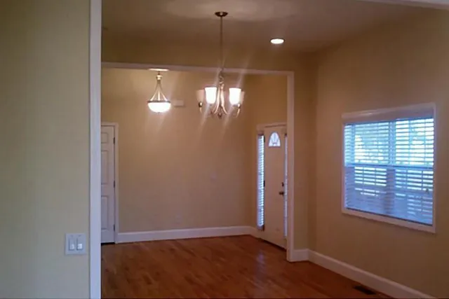 a view of a room with window and wooden floor