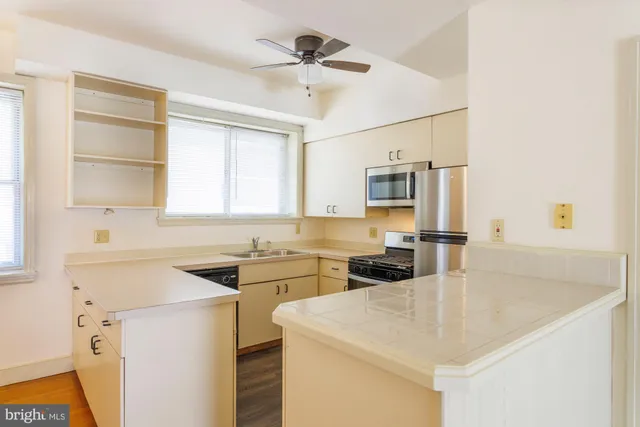 a kitchen with a sink a stove and microwave