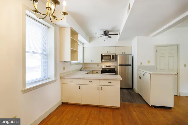 a kitchen with stainless steel appliances granite countertop a sink a stove and refrigerator