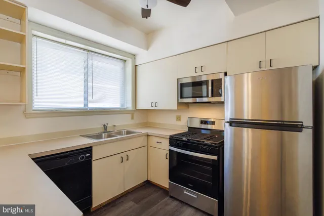 a kitchen with a refrigerator sink and stove