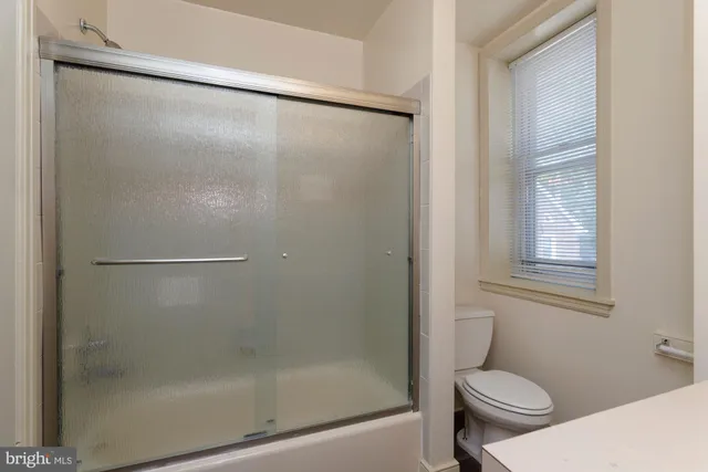 a bathroom with a shower and a toilet