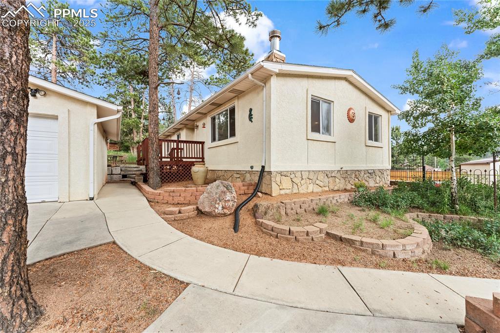 8025 Topeka Avenue Cascade, CO 80809 - Photo 15 of 42 a view of a white house with a patio