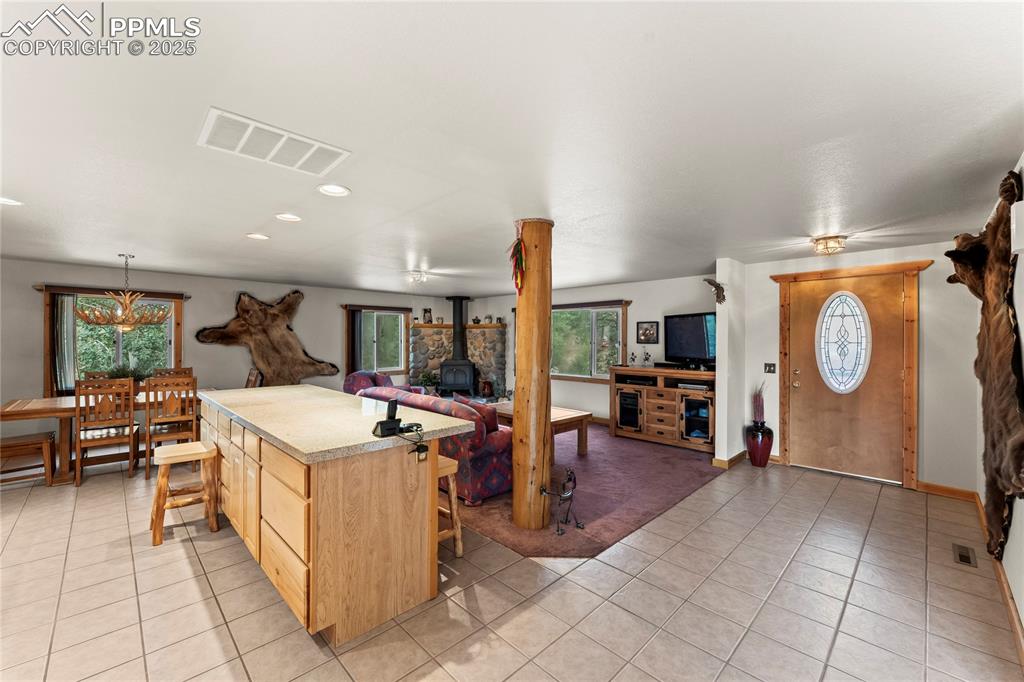 8025 Topeka Avenue Cascade, CO 80809 - Photo 17 of 42 a kitchen with stainless steel appliances kitchen island granite countertop a sink and cabinets