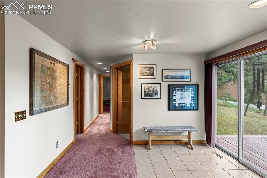 8025 Topeka Avenue Cascade, CO 80809 - Photo 24 of 42 a view of a hallway with furniture and windows