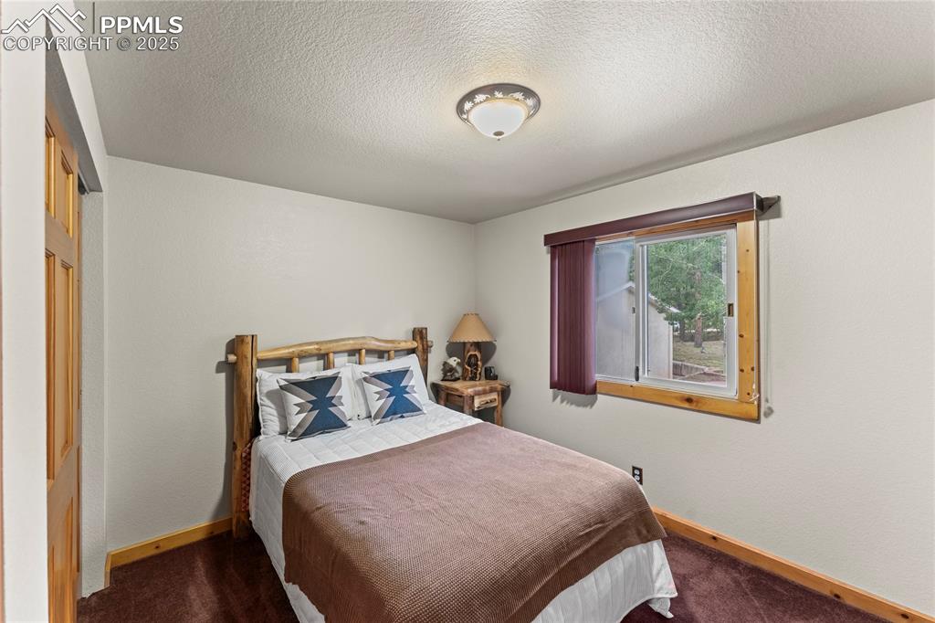 8025 Topeka Avenue Cascade, CO 80809 - Photo 31 of 42 a bedroom with a bed and a window