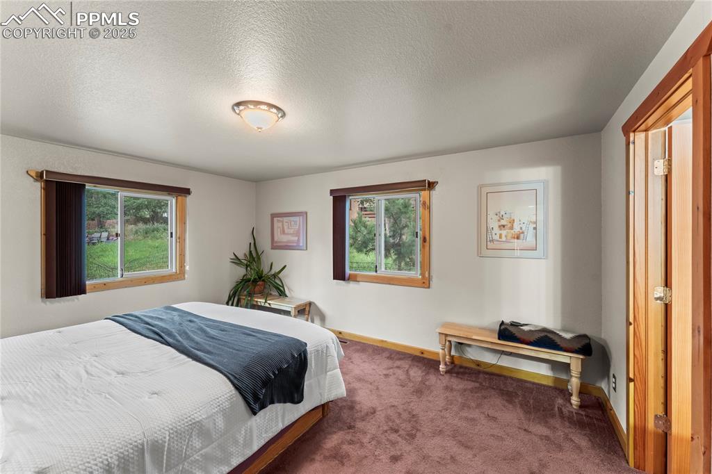 8025 Topeka Avenue Cascade, CO 80809 - Photo 34 of 42 a bedroom with a bed and a window