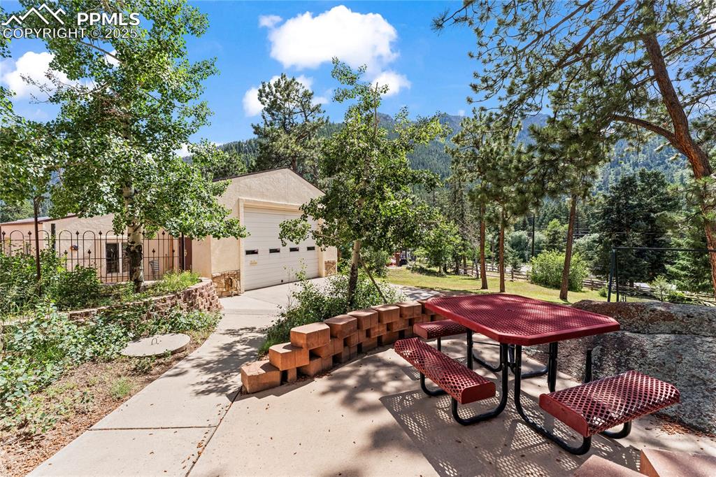 8025 Topeka Avenue Cascade, CO 80809 - Photo 4 of 42 a backyard of a house with table and chairs