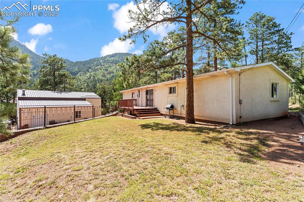 8025 Topeka Avenue Cascade, CO 80809 - Photo 5 of 42 a house view with a backyard space