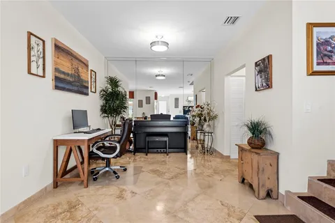 a living room with a couch and a potted plant