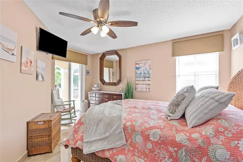 a bedroom with a bed chandelier and a window