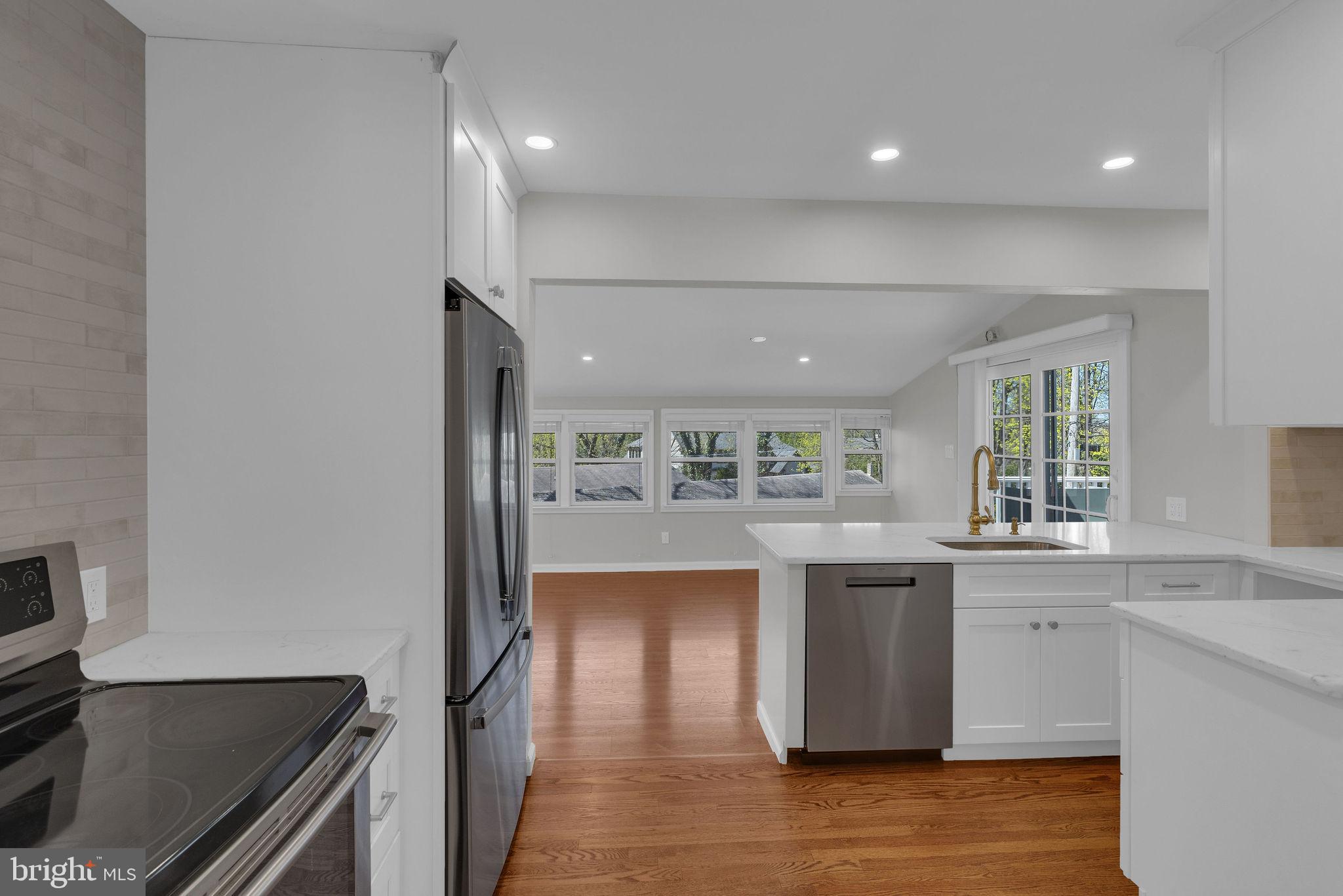 77 Davis Road Doylestown, PA 18901 - Photo 6 of 31 a kitchen with kitchen island a counter top space a sink stainless steel appliances and cabinets