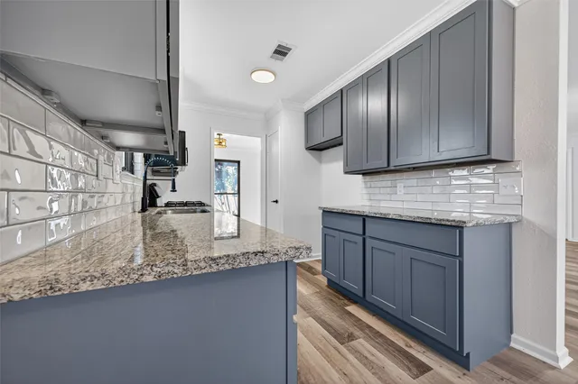 a kitchen with stainless steel appliances granite countertop wooden cabinets a sink and dishwasher