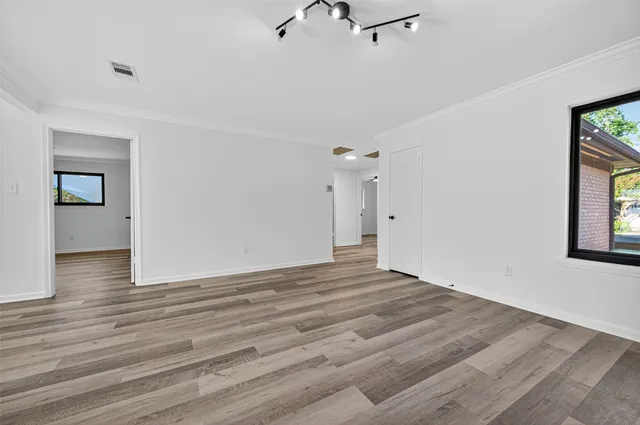 wooden floor in an empty room with a window