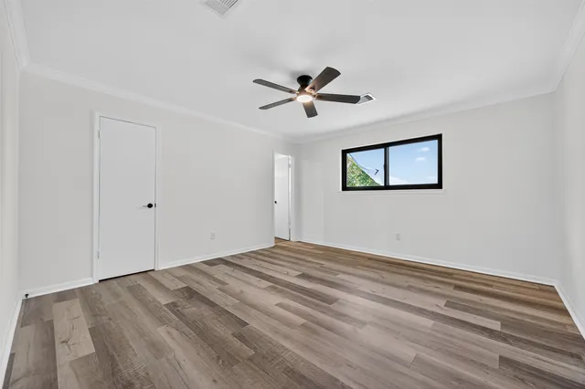 a view of empty room with wooden floor