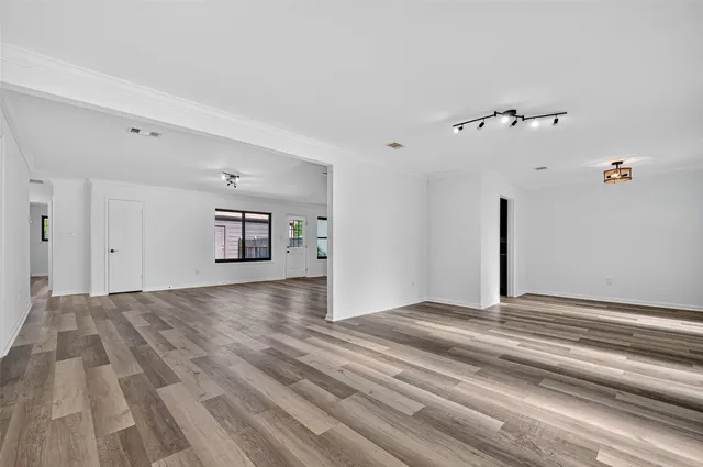 a view of empty room with wooden floor
