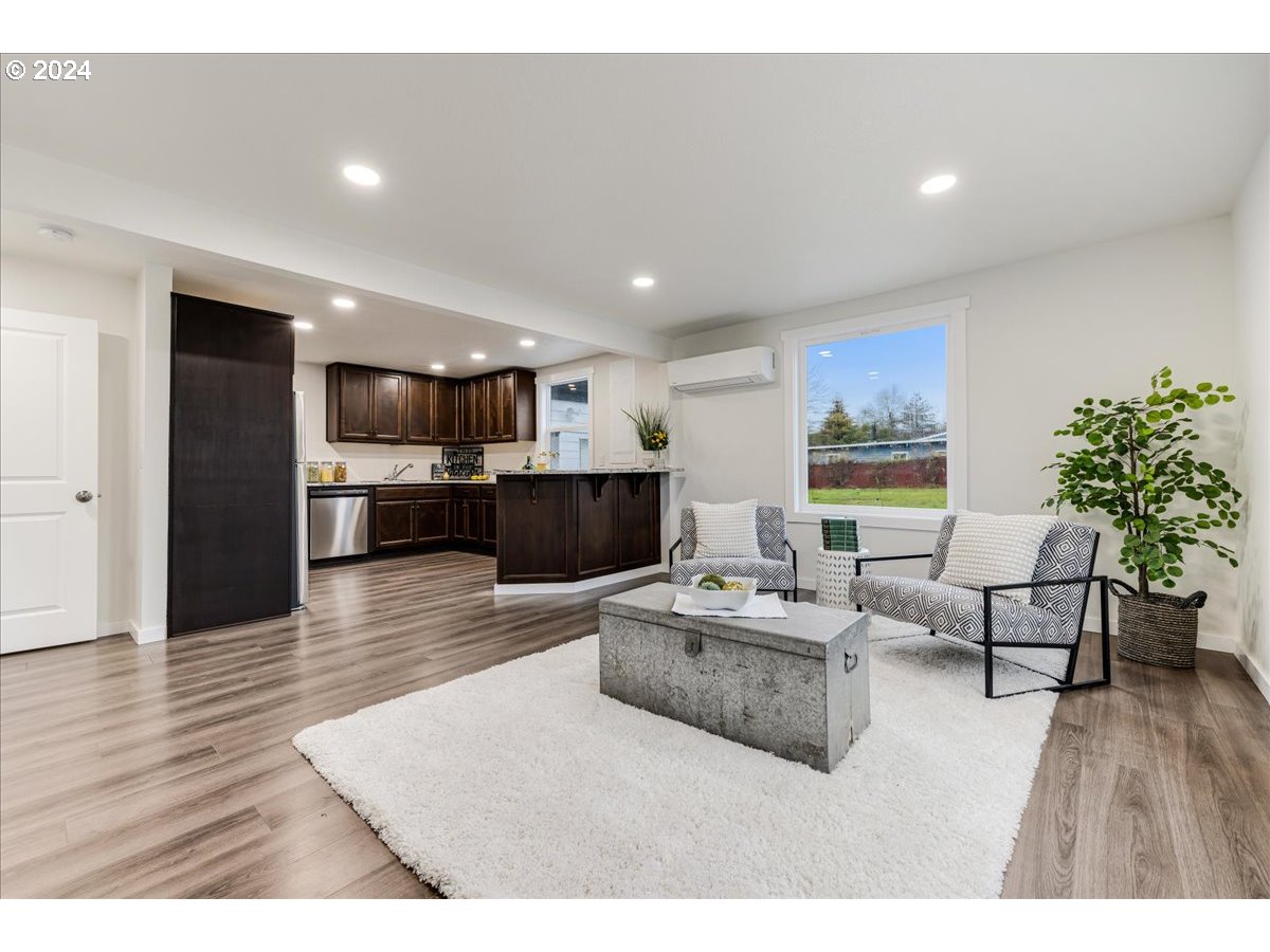 711 Southeast 5th Street Gresham, OR 97080 - Photo 13 of 44 a living room with furniture and a wooden floor