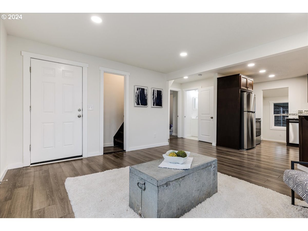 711 Southeast 5th Street Gresham, OR 97080 - Photo 14 of 44 a living room with kitchen island granite countertop furniture and a wooden floor