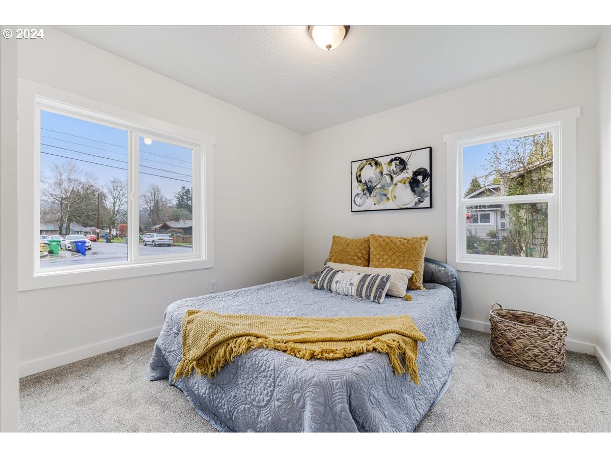 711 Southeast 5th Street Gresham, OR 97080 - Photo 22 of 44 a bedroom with a bed and a painting on the wall