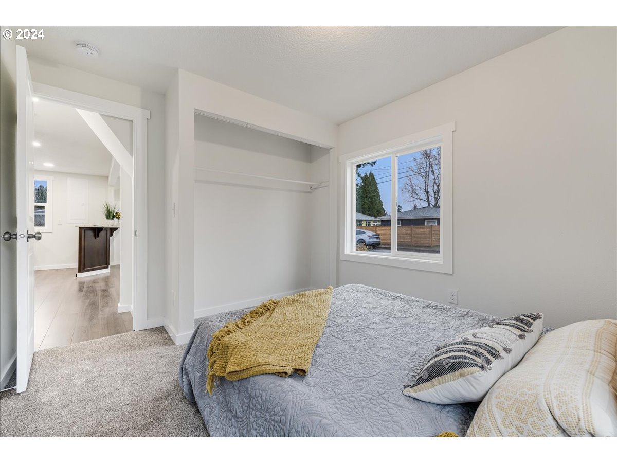 711 Southeast 5th Street Gresham, OR 97080 - Photo 23 of 44 a view of a bedroom with a bed