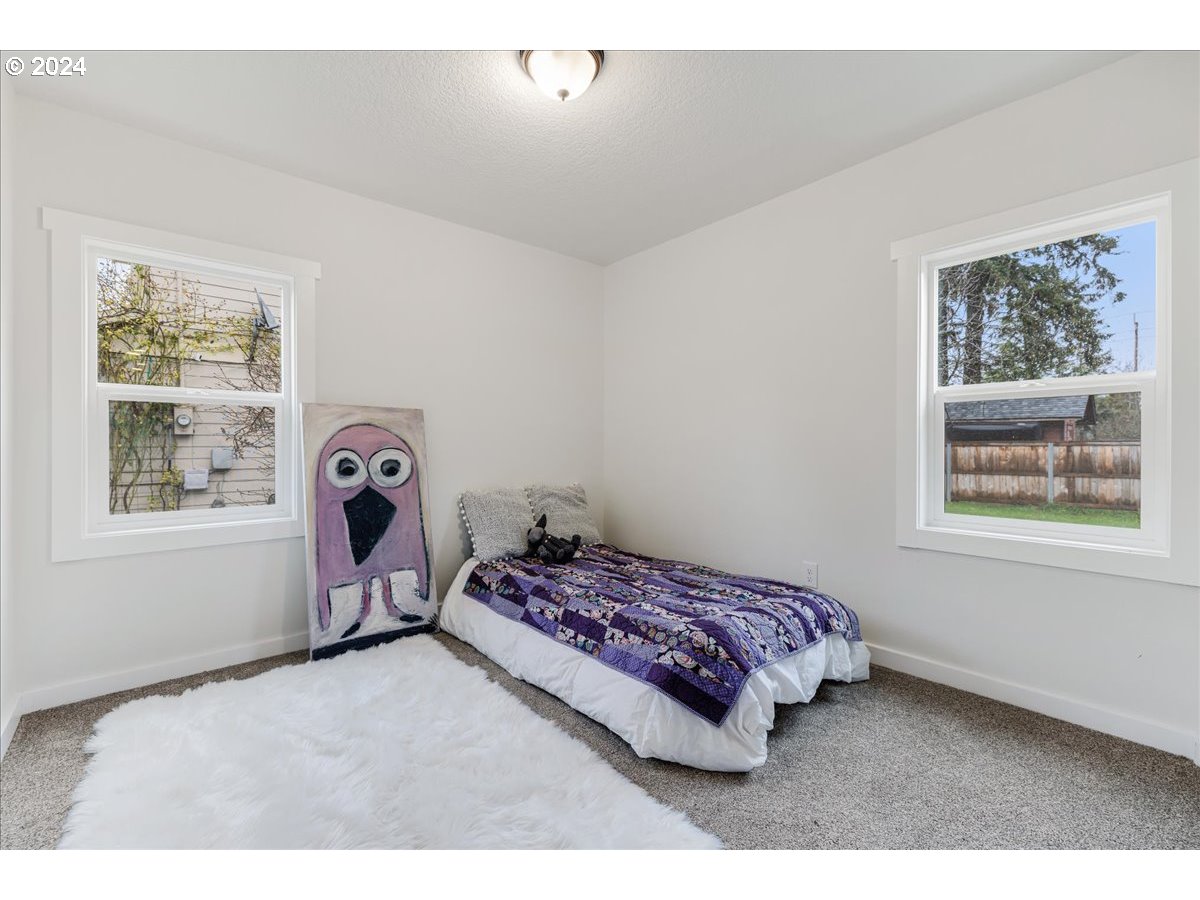 711 Southeast 5th Street Gresham, OR 97080 - Photo 24 of 44 a bedroom with a bed and a window